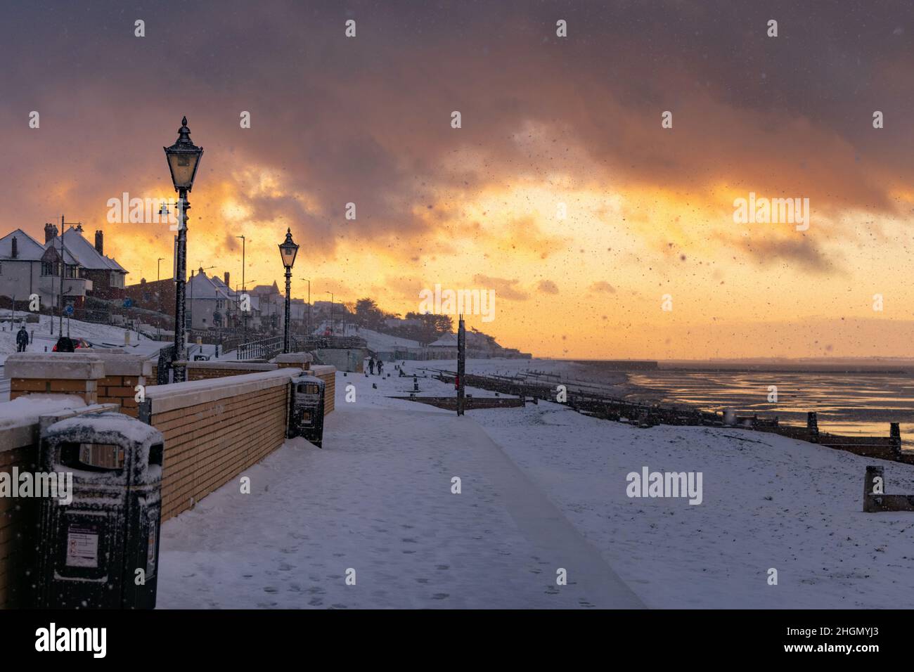 Herne Bay - a look west during the back-edge of a heavy snow shower that occurred before sunset. The beach and Sheppey can be seen coated in snow. Stock Photo