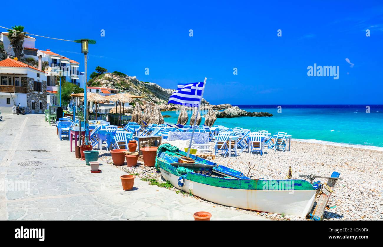 Samos island, Greece. Beautiful beach and tavern in scenic Kokkari village. popular tourist destination for summer holidays Stock Photo