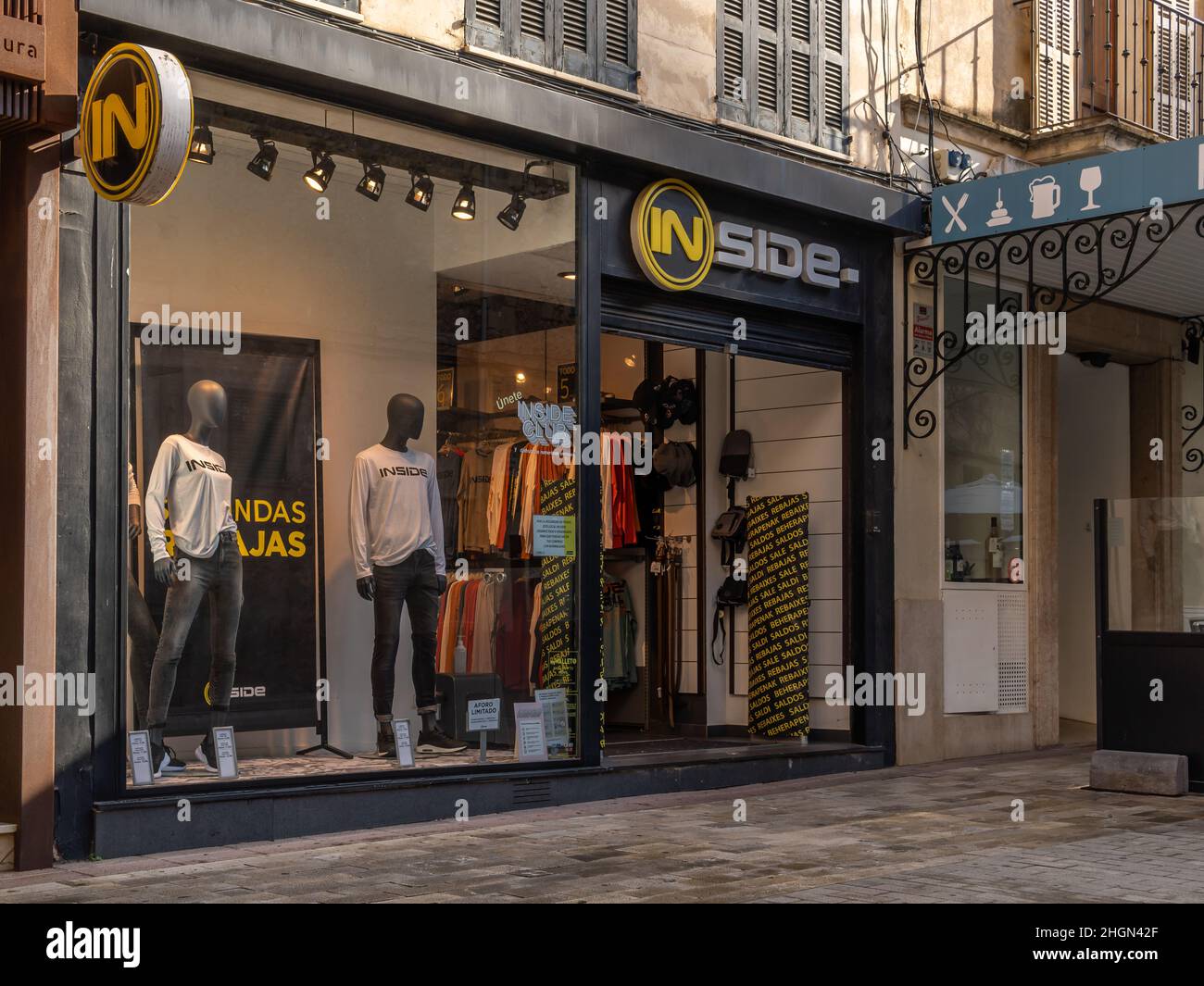 Manacor, Spain; january 20 2022: Facade of the multinational clothing and  accessories company Inside, a sunny morning with people wearing mask. New  no Stock Photo - Alamy