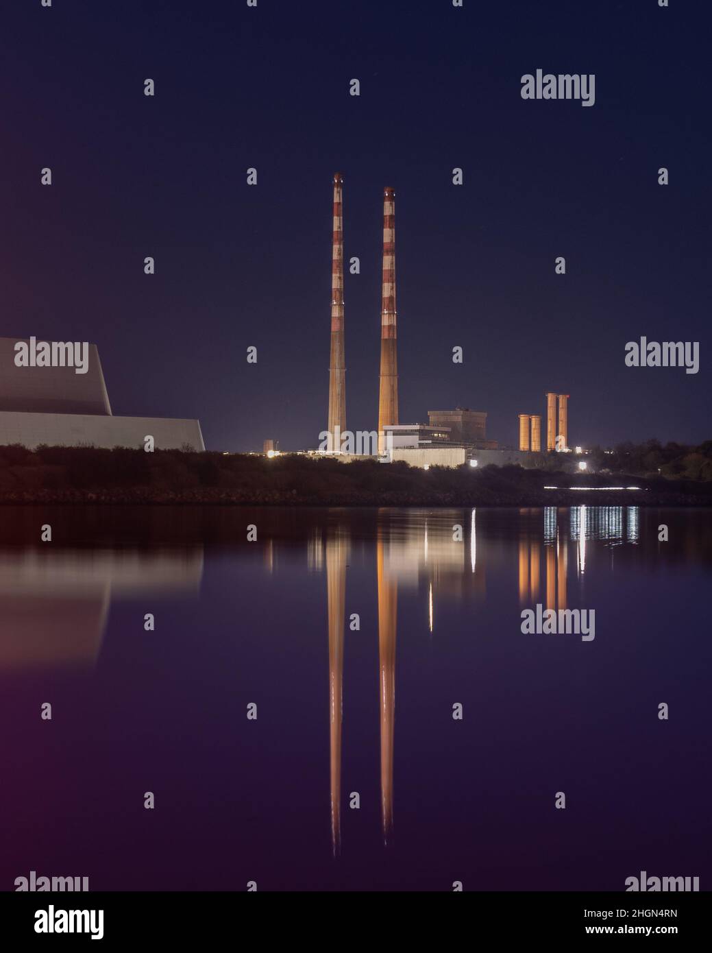 Poolbeg Chimneys reflected on Sandymount Strand during twilight Stock