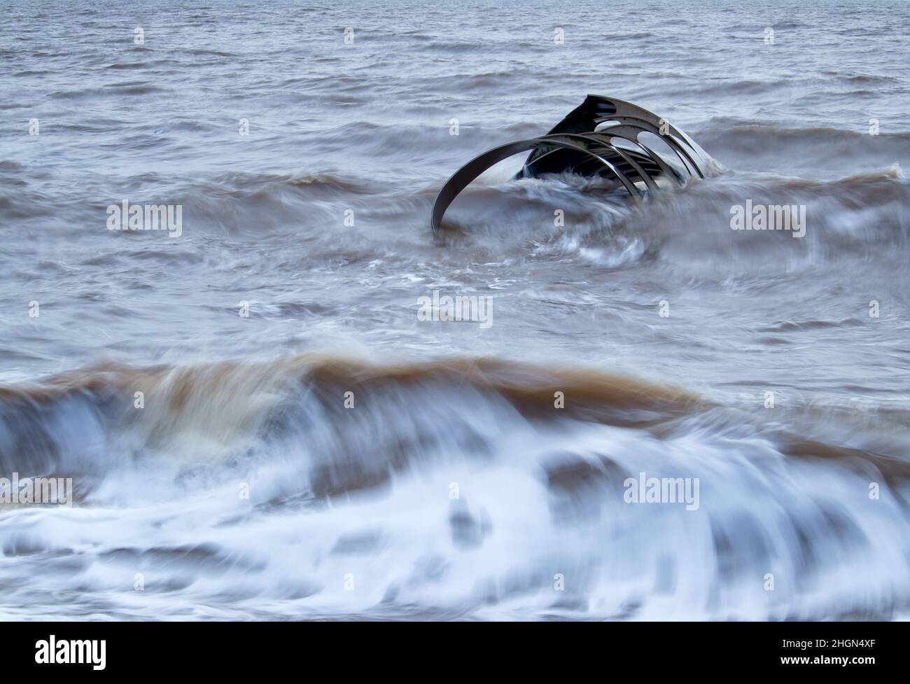 Water partly covering Mary's Golden Shell on Cleveleys beach at high tide Stock Photo