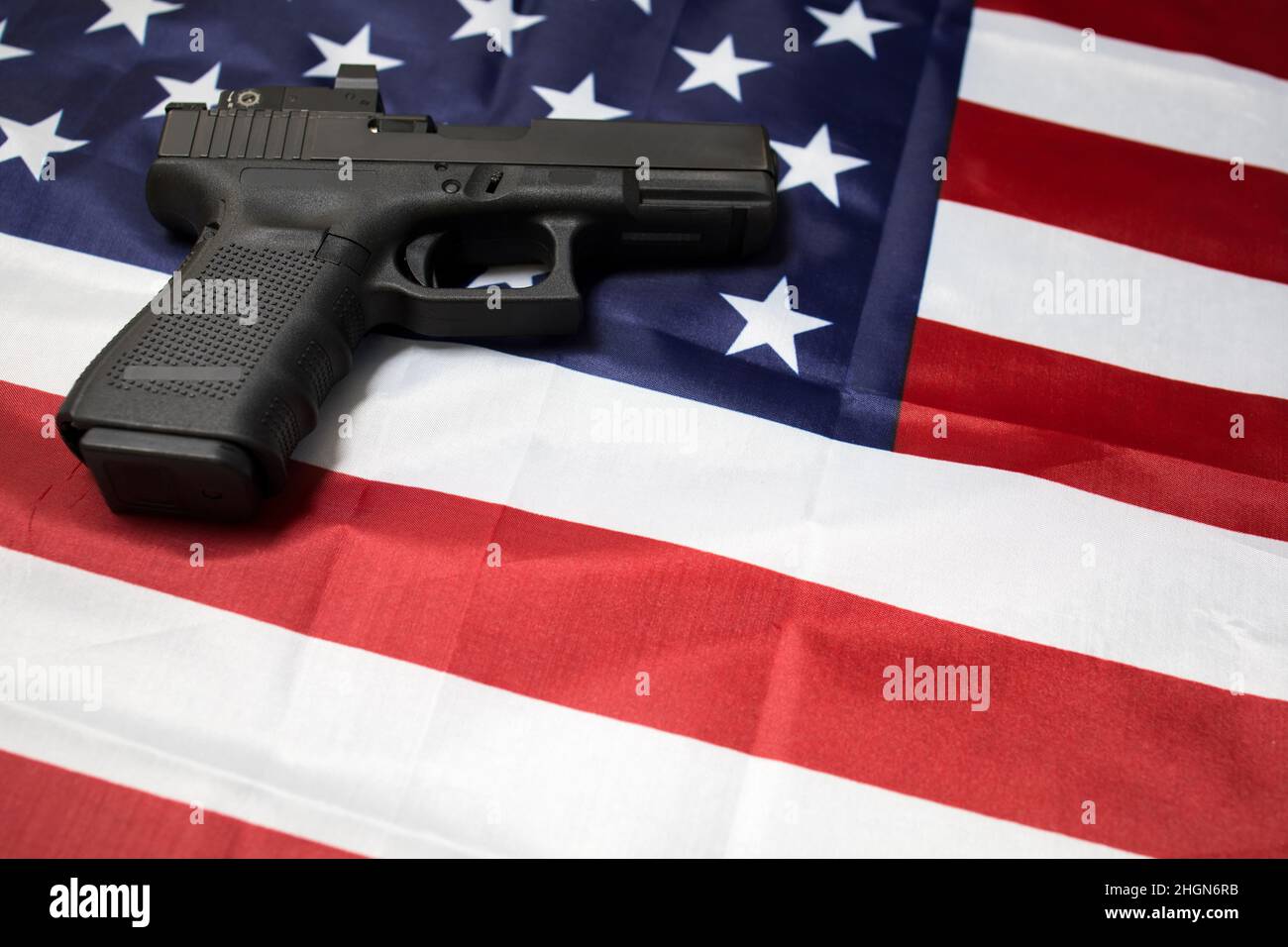 A pistol on the American flag. Gun laws in the USA. Handgun, self