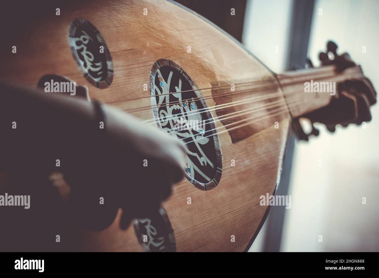 Musician Playing Note on Instrument Oud during the concert Stock Photo