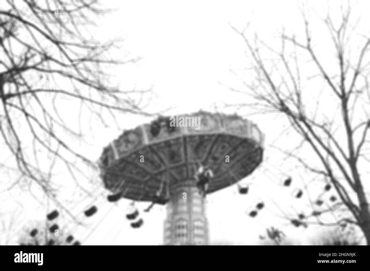 Blurry defocused photo of  chain carousel in motion. Dreamy nostalgia background. Black white historic photo Stock Photo