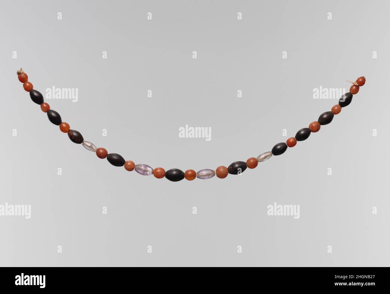 String of beads ca. 2030–1640 B.C. Middle Kingdom. String of beads. ca. 2030–1640 B.C.. Carnelian, amethyst, garnet, hematite; modern string. Middle Kingdom. From Egypt, Northern Upper Egypt, Abadiya, Cemetery G, Tomb G6, EEF excavations 1898–99. Dynasty 12 Stock Photo