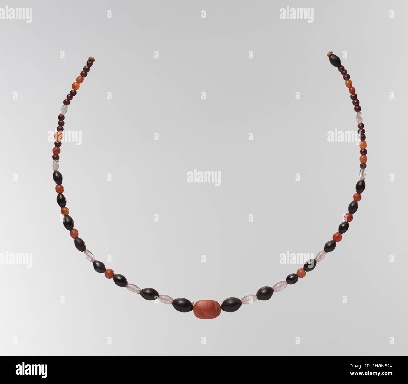 String of beads with scarab ca. 2030–1640 B.C. Middle Kingdom. String of beads with scarab. ca. 2030–1640 B.C.. Carnelian, amethyst, garnet, hematite; modern string. Middle Kingdom. From Egypt, Northern Upper Egypt, Abadiya, Cemetery G, Tomb G6, EEF excavations 1898–99. Dynasty 12 Stock Photo