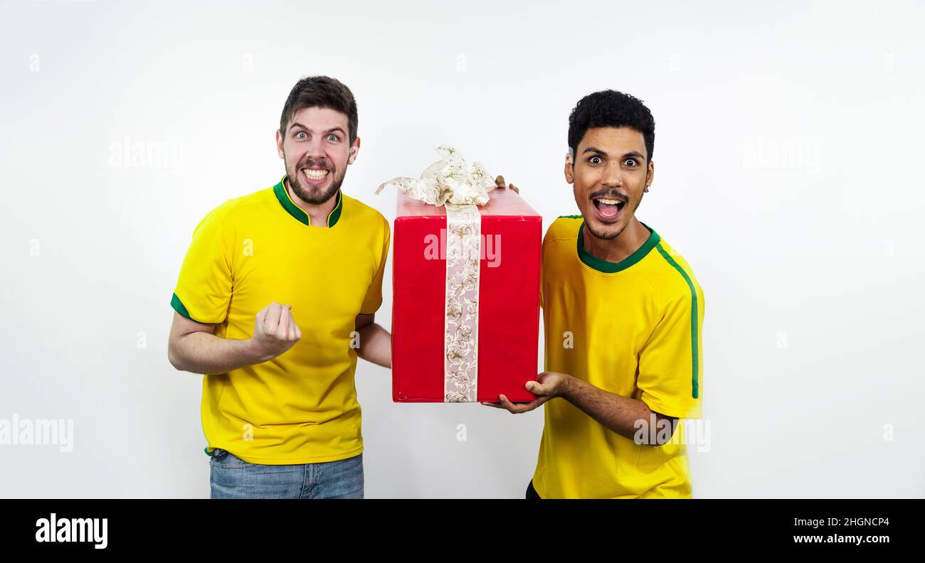 Group of soccer brazilians friends with a red gift isolated on white Stock Photo