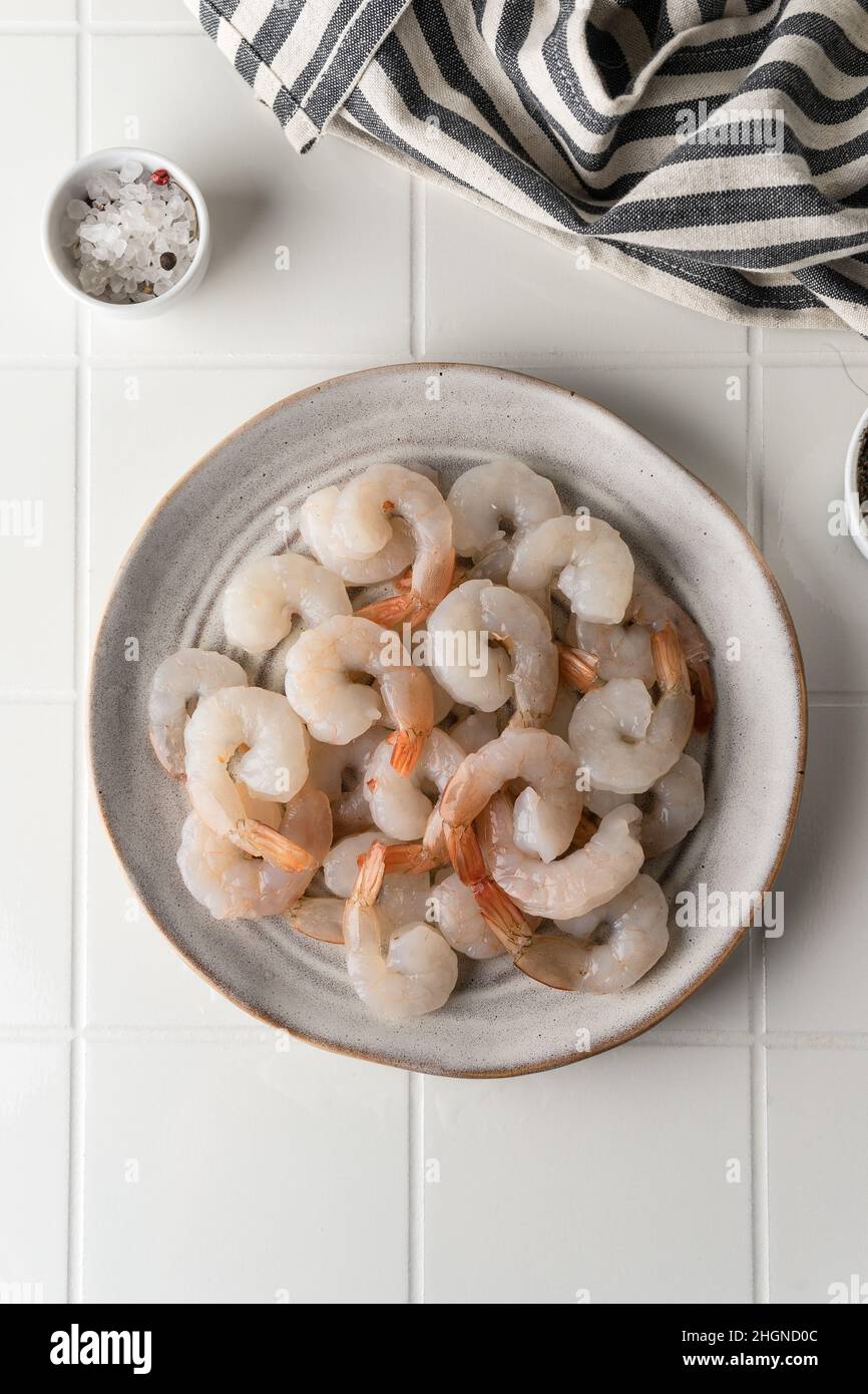 Thawed peeled shrimp, seafood, delicacy. on a white background, in a