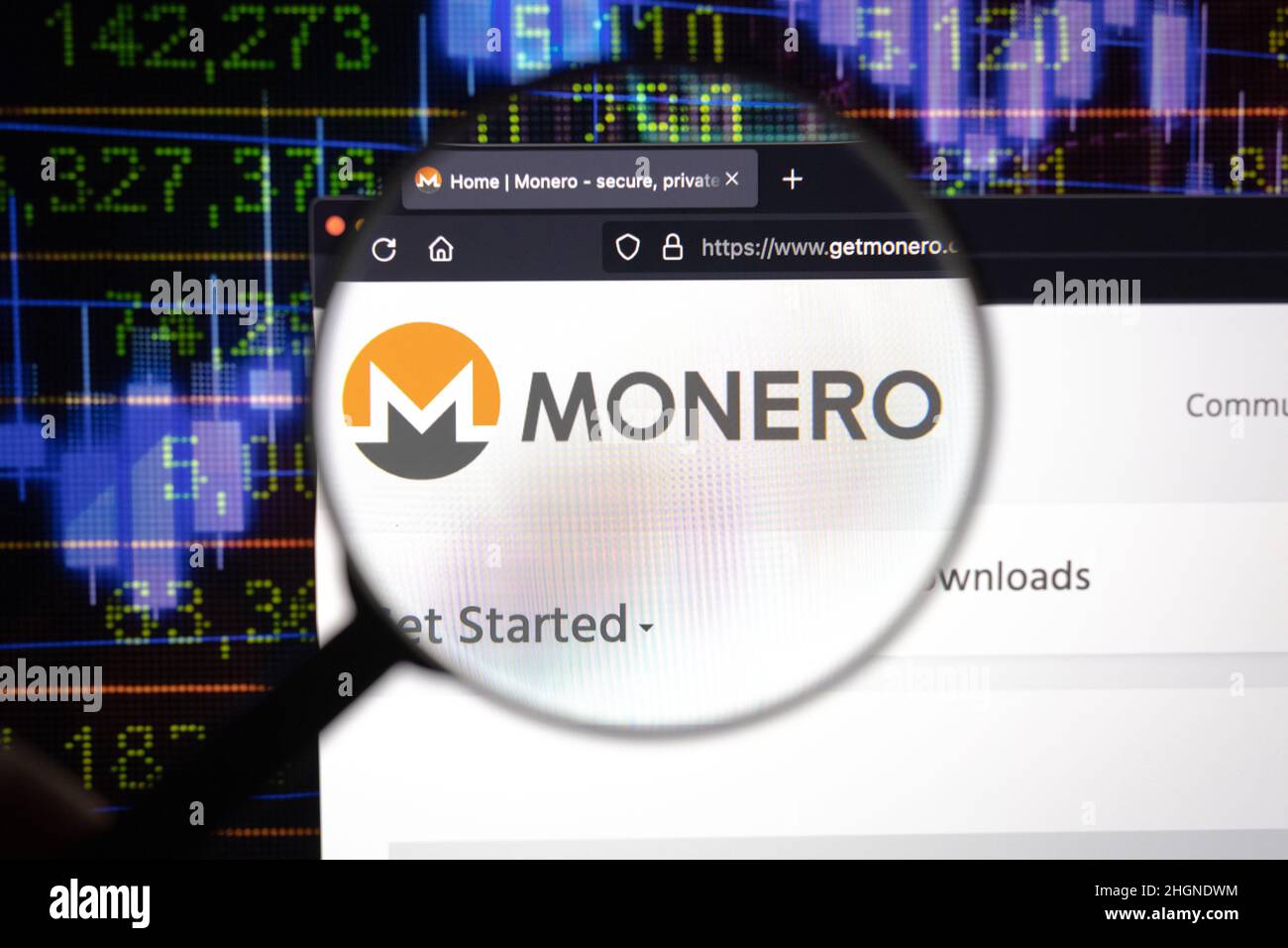 Monero crypto company logo on a website, seen on a computer screen through a magnifying glass