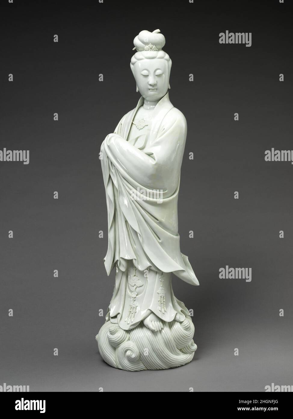 White-Robed Guanyin 18th century China The ivory white porcelain of the Dehua kilns of Fujian was well-suited to representing Guanyin, especially in her white?robed form, and the kiln produced countless sculptures of the bodhisattva to meet the public’s insatiable demand. This is a particularly grand example, befitting a wealthy residence.. White-Robed Guanyin. China. 18th century. Porcelain with white glaze (Dehua ware). Qing dynasty (1644–1911). Ceramics Stock Photo