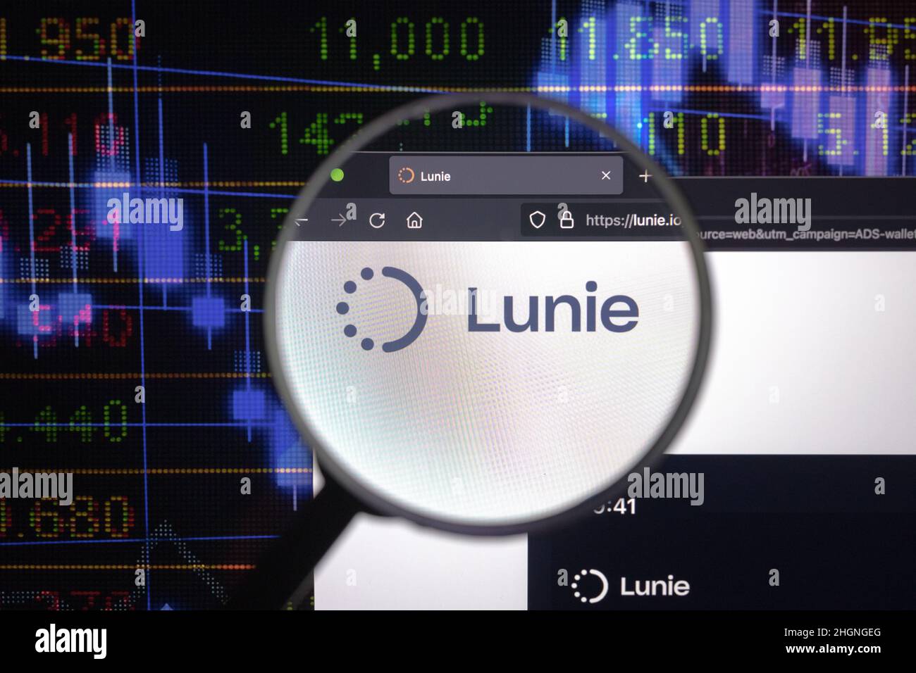 Lunie crypto company logo on a website, seen on a computer screen through a magnifying glass. Stock Photo