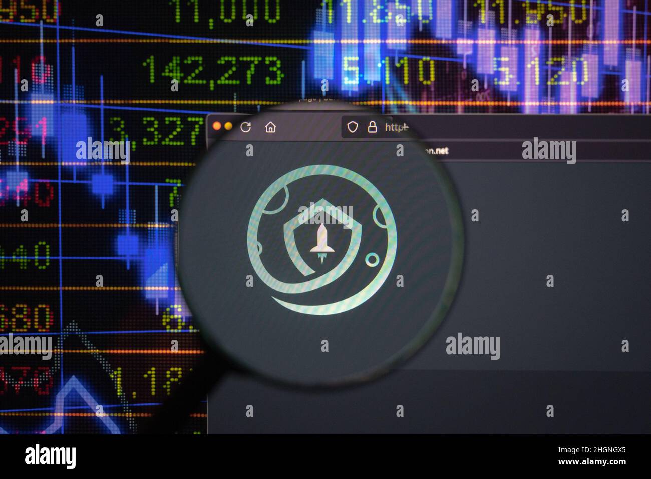 Safemoon crypto company logo on a website, seen on a computer screen through a magnifying glass. Stock Photo