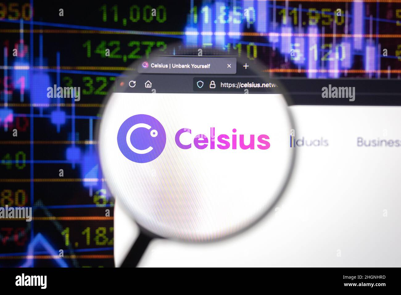 Celsius crypto company logo on a website, seen on a computer screen through a magnifying glass. Stock Photo