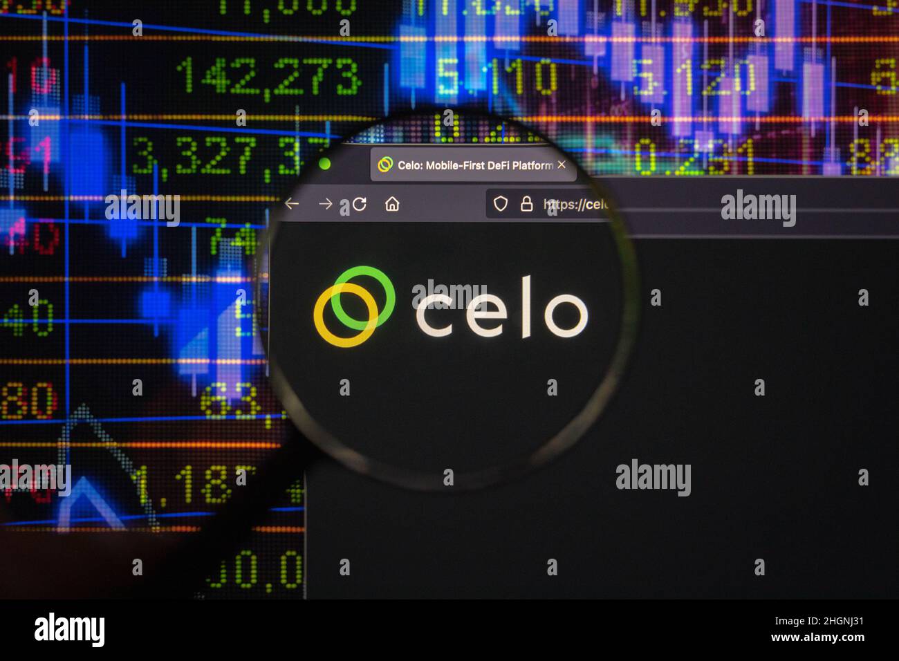 Celo crypto company logo on a website, seen on a computer screen through a magnifying glass. Stock Photo