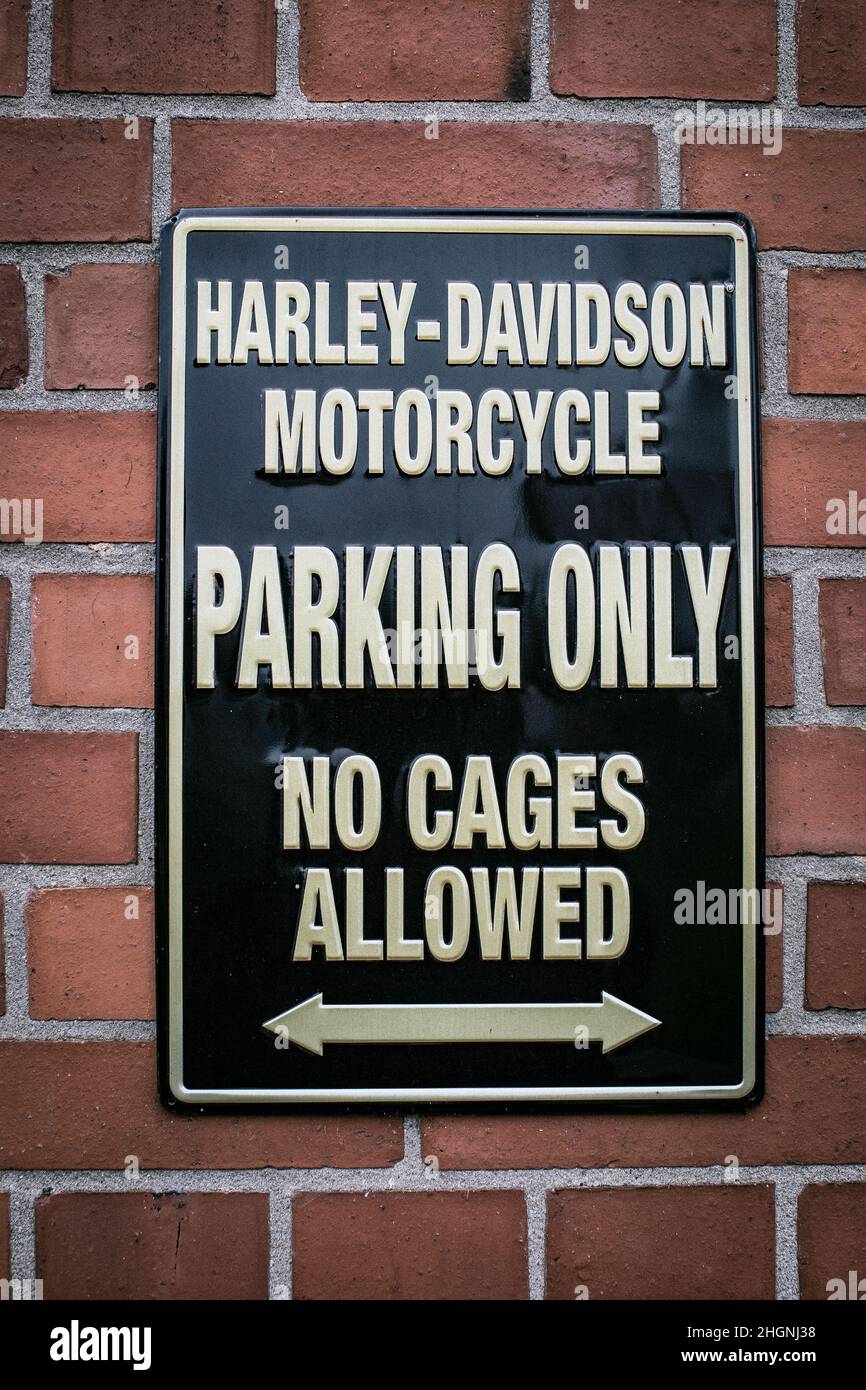 harley davidson parking only sign on brick wall Stock Photo