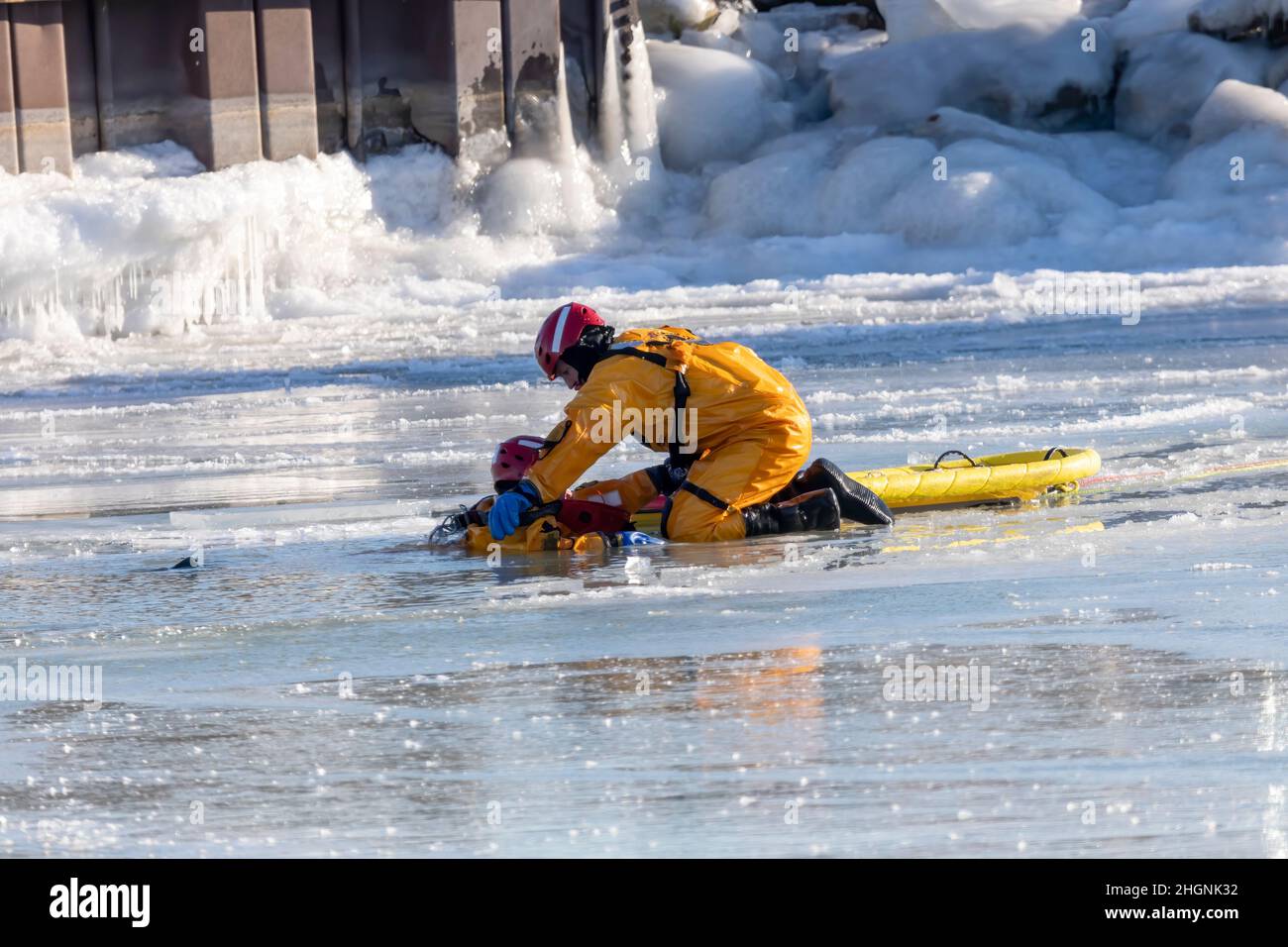 Two Rivers, WI USA January 21 2022: the fire rescue team is practicing rescuing a drowning person on a frozen river Stock Photo