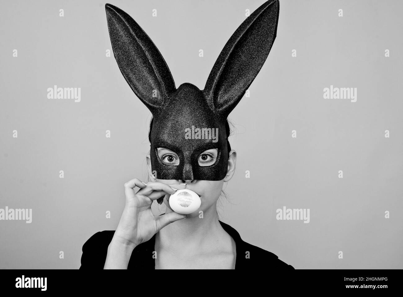 Lipstick kiss print on easter egg. Happy easter. Girl with lace bunny ears. Bunny woman. Easter bunny woman, rabbit and girl. Stock Photo