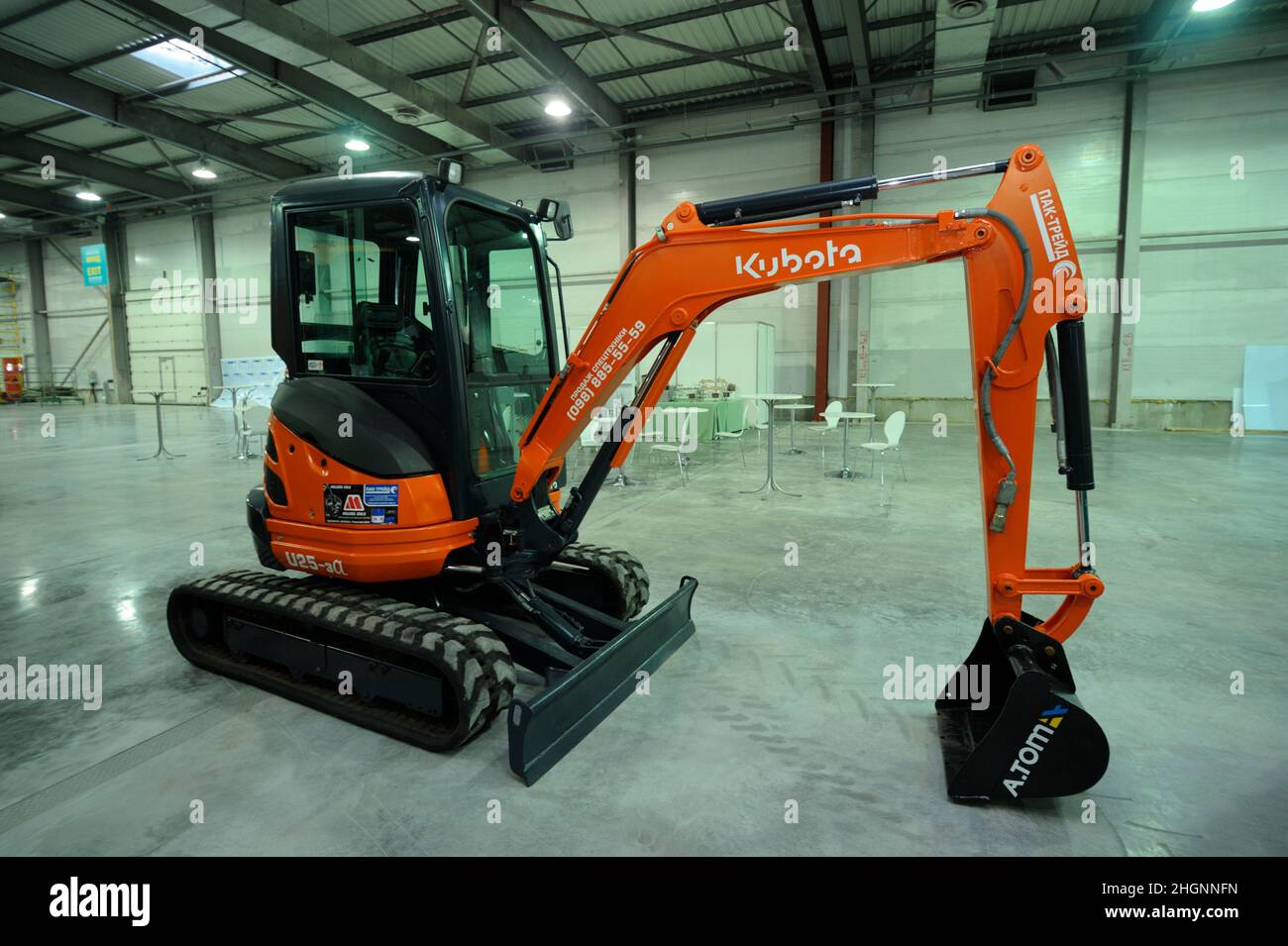 New model of mini backhoe Kubota presented on a stand. Exhibition Heavy