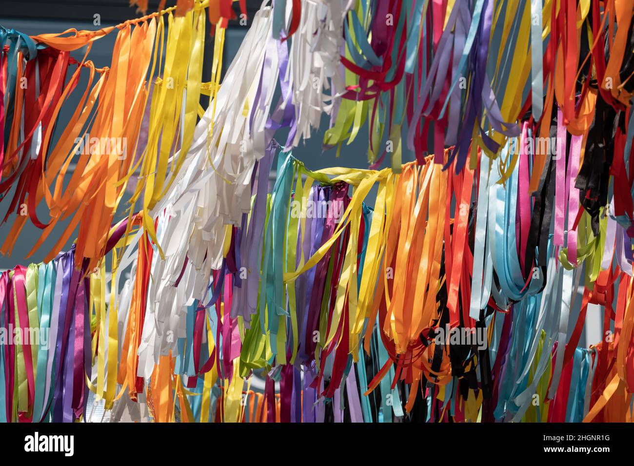 Multicolored ribbons festive decoration abstract background. Stock Photo
