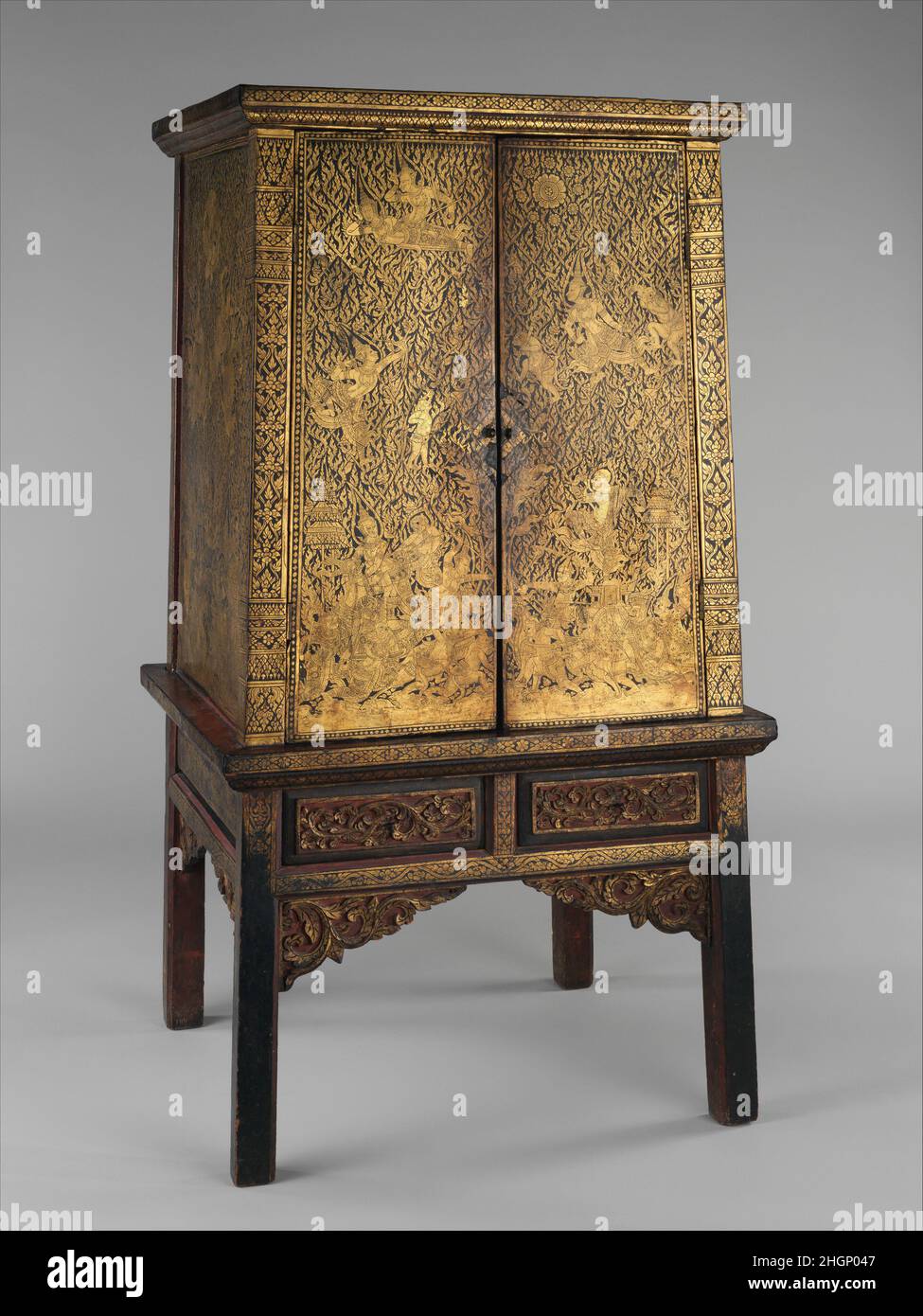 Manuscript Storage Cabinet late 18th–early 19th century Thailand (Bangkok) Cabinets of this type were traditionally gifted to monasteries where they served to house and preserve the sacred scriptures written on palm-leaf manuscripts, and associated Buddhist texts often on khoi paper, such as those narrating the adventures of the venerable monk Pra Malai. These cabinets were richly decorated with gold on lacquer ground in a technique known as Lai Rod Nam. Depictions of celestial adorants was a favored subject, as was combatant scenes from the Ramakien, the Thai version of the Indian epic, the R Stock Photo