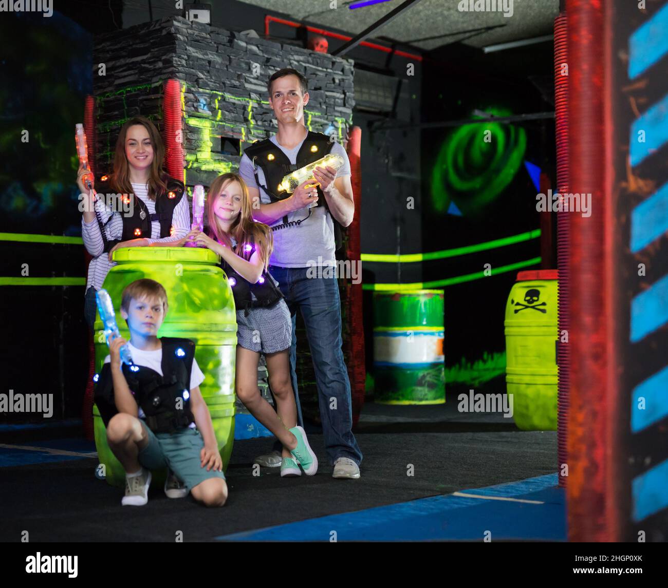 Kds and adults posing with laser guns Stock Photo Alamy
