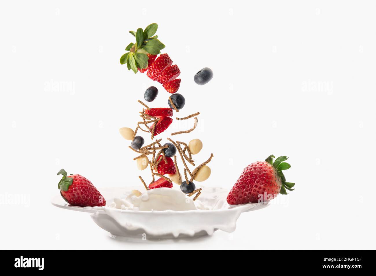 Cereals fiber with strawberry, almonds and blueberry falling and
