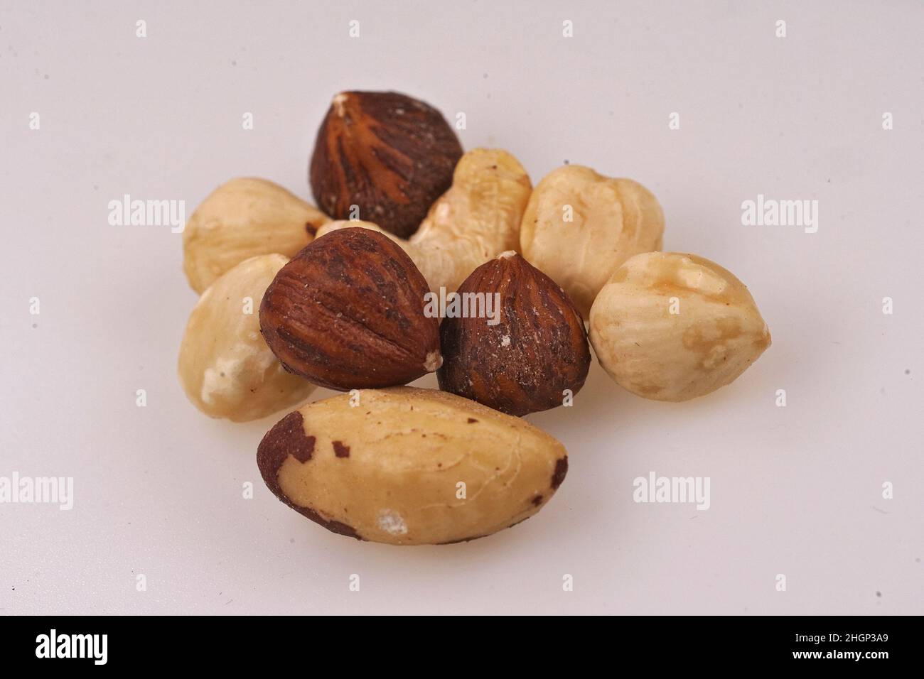 Closeup on natural healthy protein nourishment , an aggregation of various nuts on white background Stock Photo