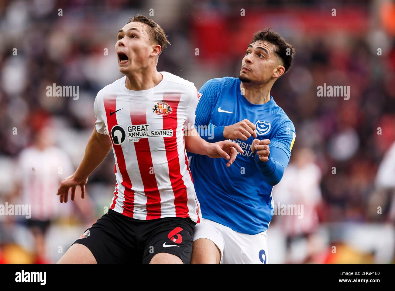 Sunderland, UK. 22nd Jan, 2022. Callum Doyle of Sunderland and Tyler Walker of Portsmouth during the Sky Bet League One match between Sunderland and Portsmouth at Stadium of Light on January 22nd 2022 in Sunderland, England. (Photo by Daniel Chesterton/phcimages.com) Credit: PHC Images/Alamy Live News Stock Photo