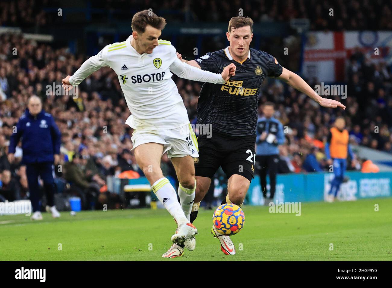 Leeds, UK. 22nd Jan, 2022. Diego Llorente #14 of Leeds United passes back under pressure from Chris Wood #20 of Newcastle United during the Premier League fixture Leeds United vs Newcastle United at Elland Road, Leeds, UK, 22nd January 2022 Credit: News Images /Alamy Live News Stock Photo