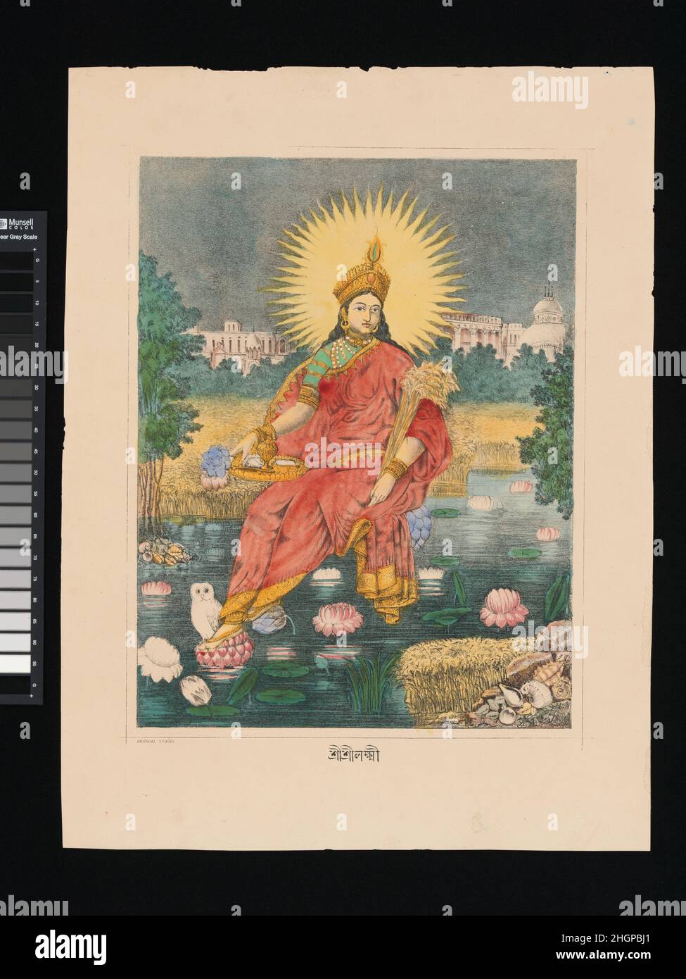 Shri Shri Lakshmi ca. 1880 India Lakshmi enthroned on lotus, with a radiate solar halo, cornucopia-like bundle of wheat and toga-like sari attesting to the strong connection between this print and European depictions of Greek gods. The buildings in the background juxtapose traditional Bengali temple architecture with the neo-classical European architecture of colonial Calcutta, further amplifying the casting of a traditional deity in neo-classical guise.. Shri Shri Lakshmi. India. ca. 1880. Lithograph with hand-coloring. Prints Stock Photo