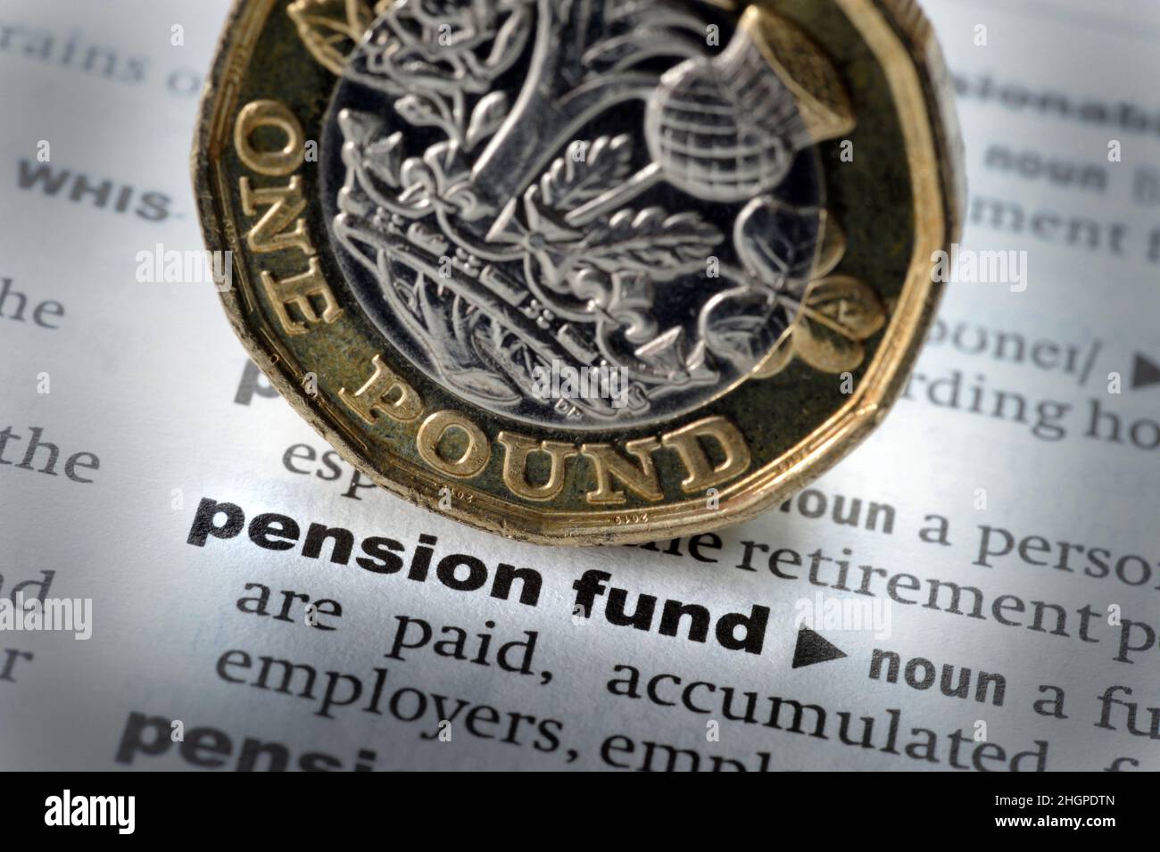 DICTIONARY DEFINITION OF WORDS PENSION FUND WITH ONE POUND COIN RE PENSIONS RETIREMENT COST OF LIVING RISING PRICES SAVINGS PENSIONERS ETC UK Stock Photo
