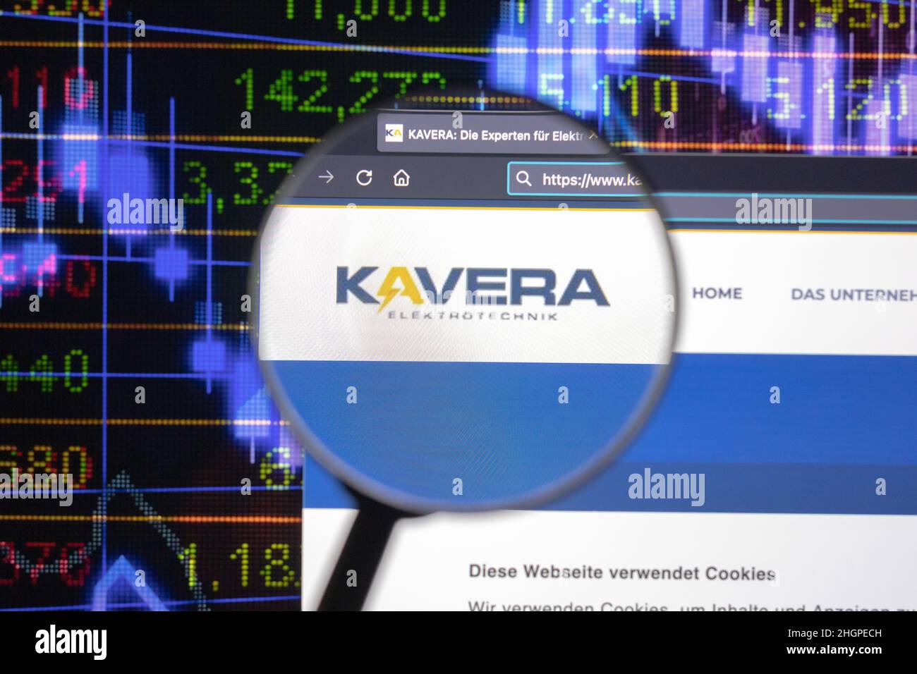 Kavera company logo on a website with blurry stock market developments in the background, seen on a computer screen through a magnifying glass. Stock Photo