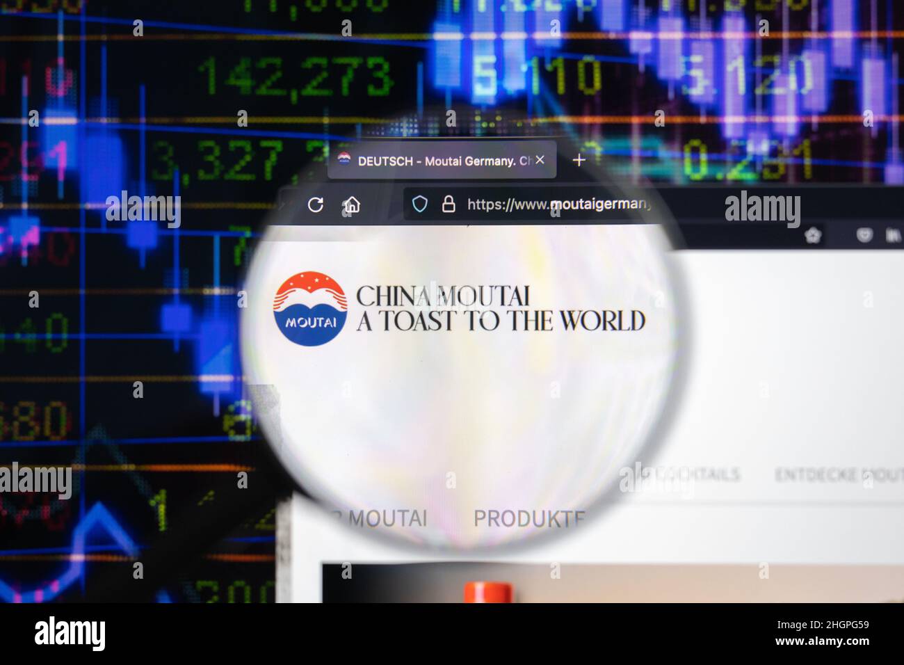 Moutai company logo on a website with blurry stock market developments in the background, seen on a computer screen through a magnifying glass. Stock Photo