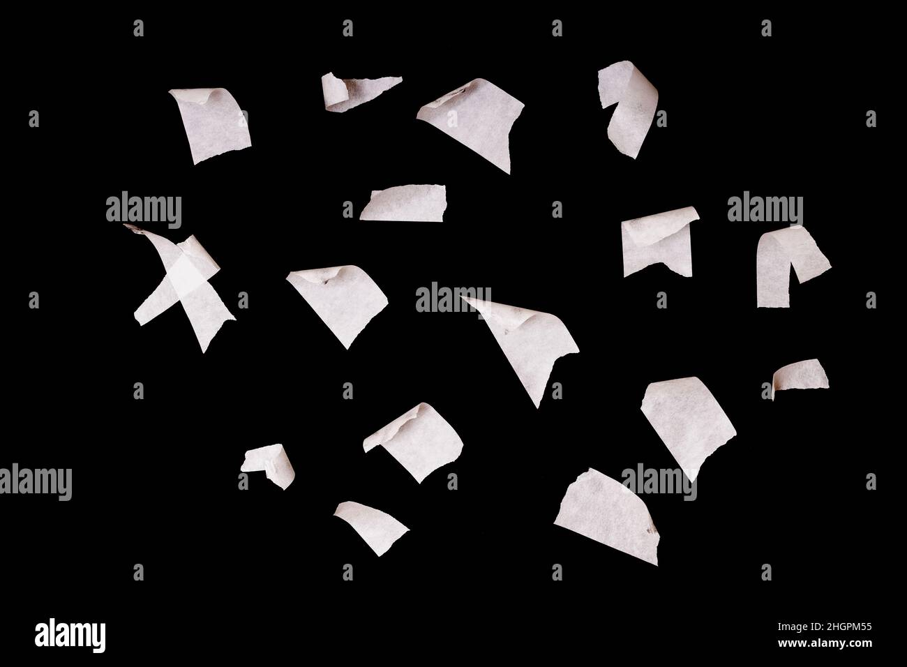 a set of pieces of white scotch tape isolated on a black background