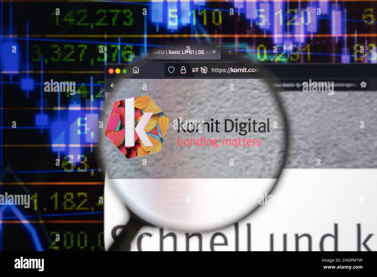 Kornit Digital company logo on a website with blurry stock market developments in the background, seen on a computer screen through a magnifying glass Stock Photo