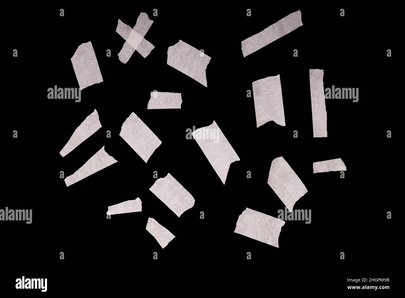a set of pieces of white scotch tape isolated on a black background