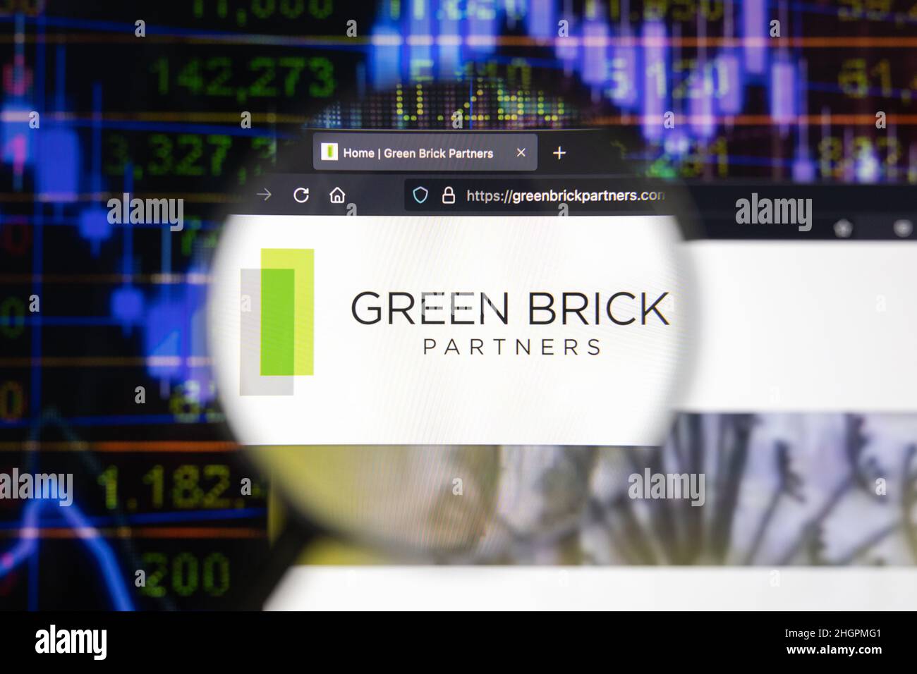 Green Brick Partners company logo on a website with blurry stock market developments in the background, seen on a computer screen Stock Photo