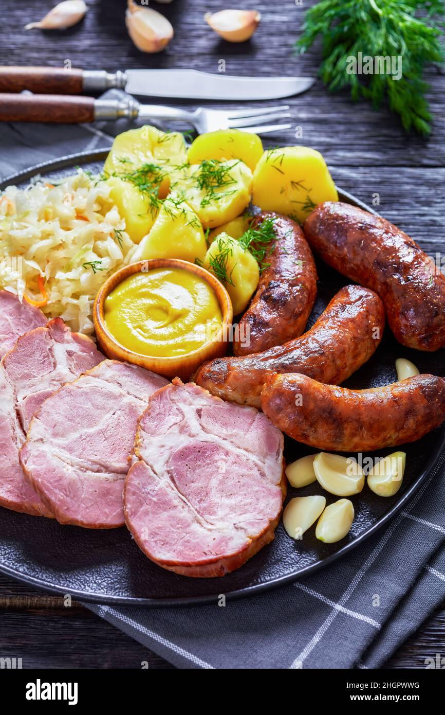 Schlachtplatte, fried bratwurst, smoked pork neck, boiled potatoes ...