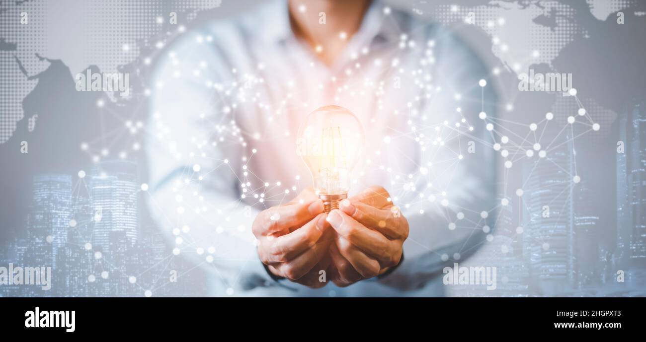 The Man hand holding light bulb with line connect and working on the ...
