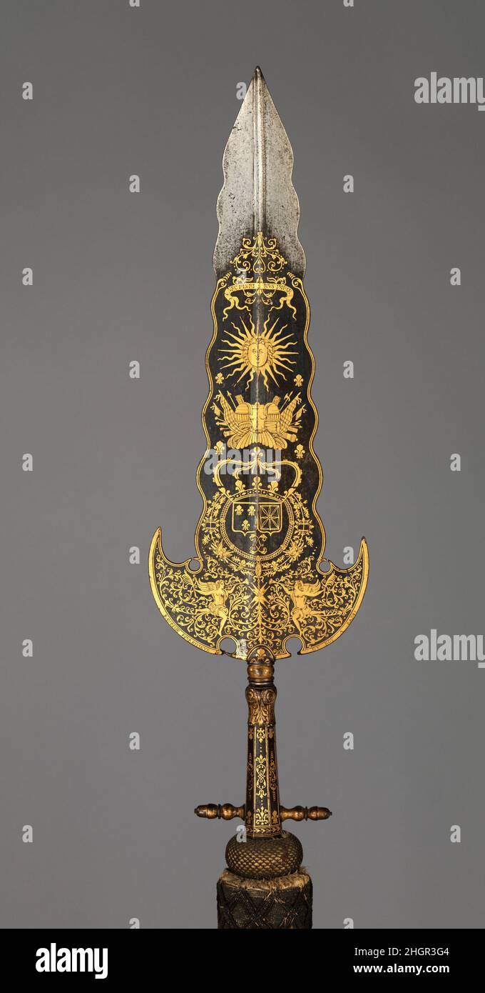 Partisan Carried by the Bodyguard of Louis XIV (1638–1715, reigned from 1643) ca. 1678–1709 Inscription probably refers to Bonaventure Ravoisie French This partisan, along with two like it also in the Metropolitan Museum's collection (acc. nos. 14.25.454, 04.3.64), are thought to have been carried by the Gardes de la Manche (literally, “guards of the sleeve,” indicating their close proximity to the king), an elite unit of the bodyguard of Louis XIV. This example (along with 04.3.64) bears the king’s motto and sunburst above the crowned arms of France and Navarre, which are encircled by the col Stock Photo