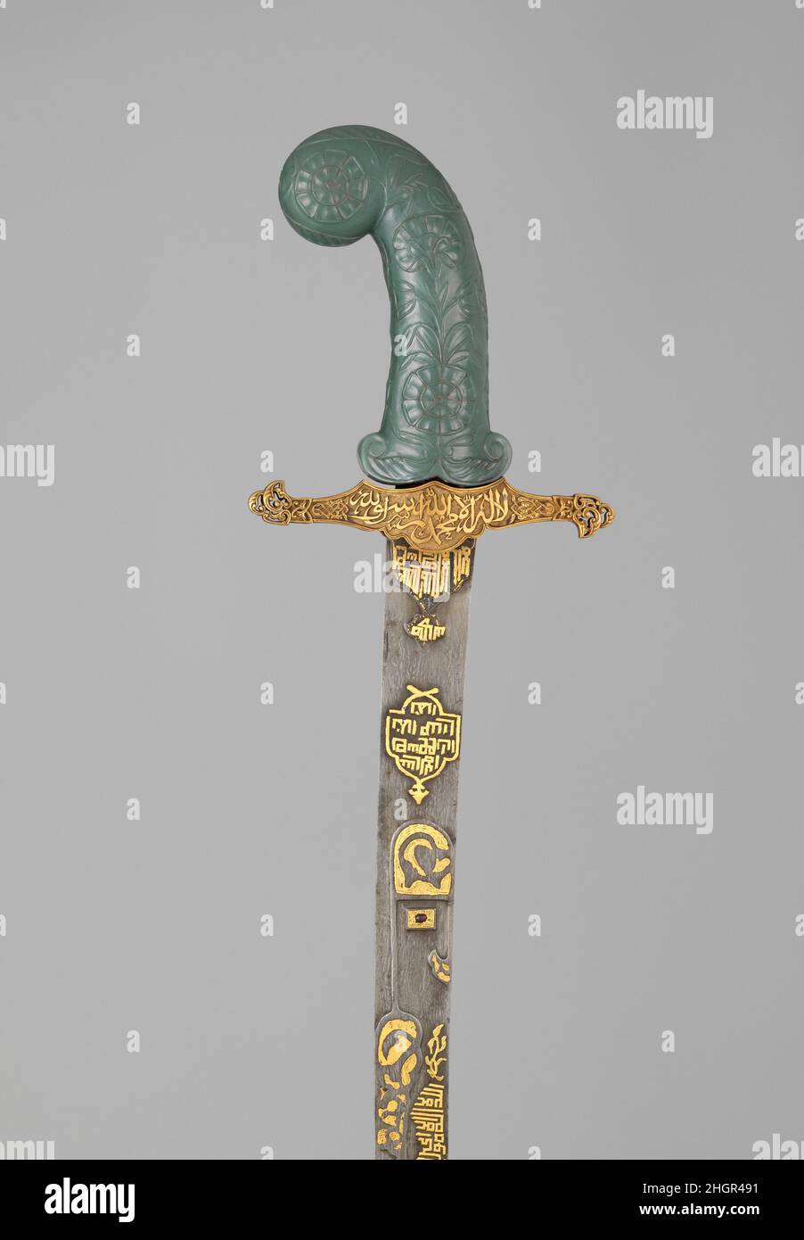 Sword (Kilij) hilt and guard, 19th century; grip, possibly 18th century hilt and guard, Turkish; grip, Indian The inscriptions on the sword invokes Allah, the Prophet Muhammad, and ‘Ali. On the sword’s blade is the Ayat al-Kursi (Throne Verse, 2:255), a popular talisman throughout the Islamic world.. Sword (Kilij). hilt and guard, Turkish; grip, Indian. hilt and guard, 19th century; grip, possibly 18th century. Steel, gold, nephrite, ruby. Swords Stock Photo