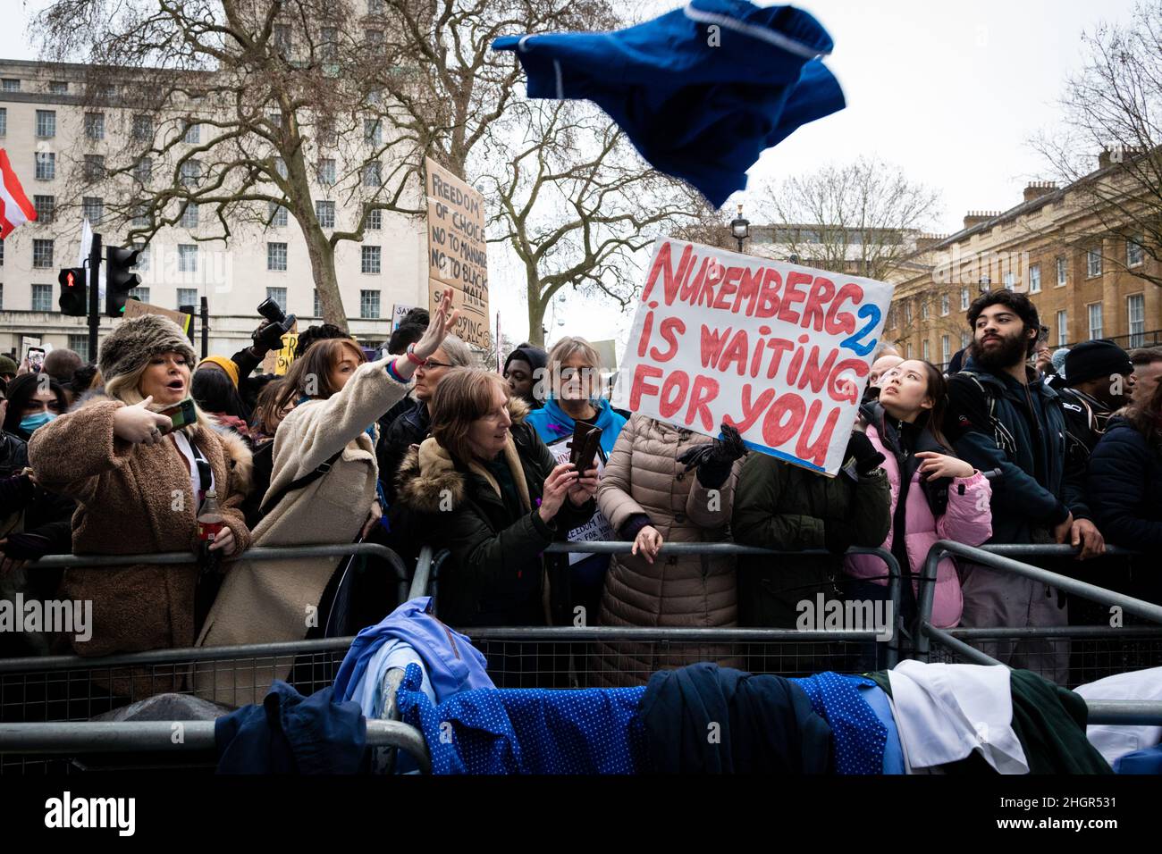 London, UK. 22nd Jan, 2022. Protesters throw NHS uniforms at Downing Street. As the mandate to get vaccinated against COVID-19 draws ever closer NHS workers join the protest. The anti-lockdown demonstration was organised by the World Wide Rally For Freedom movement. Credit: Andy Barton/Alamy Live News Stock Photo