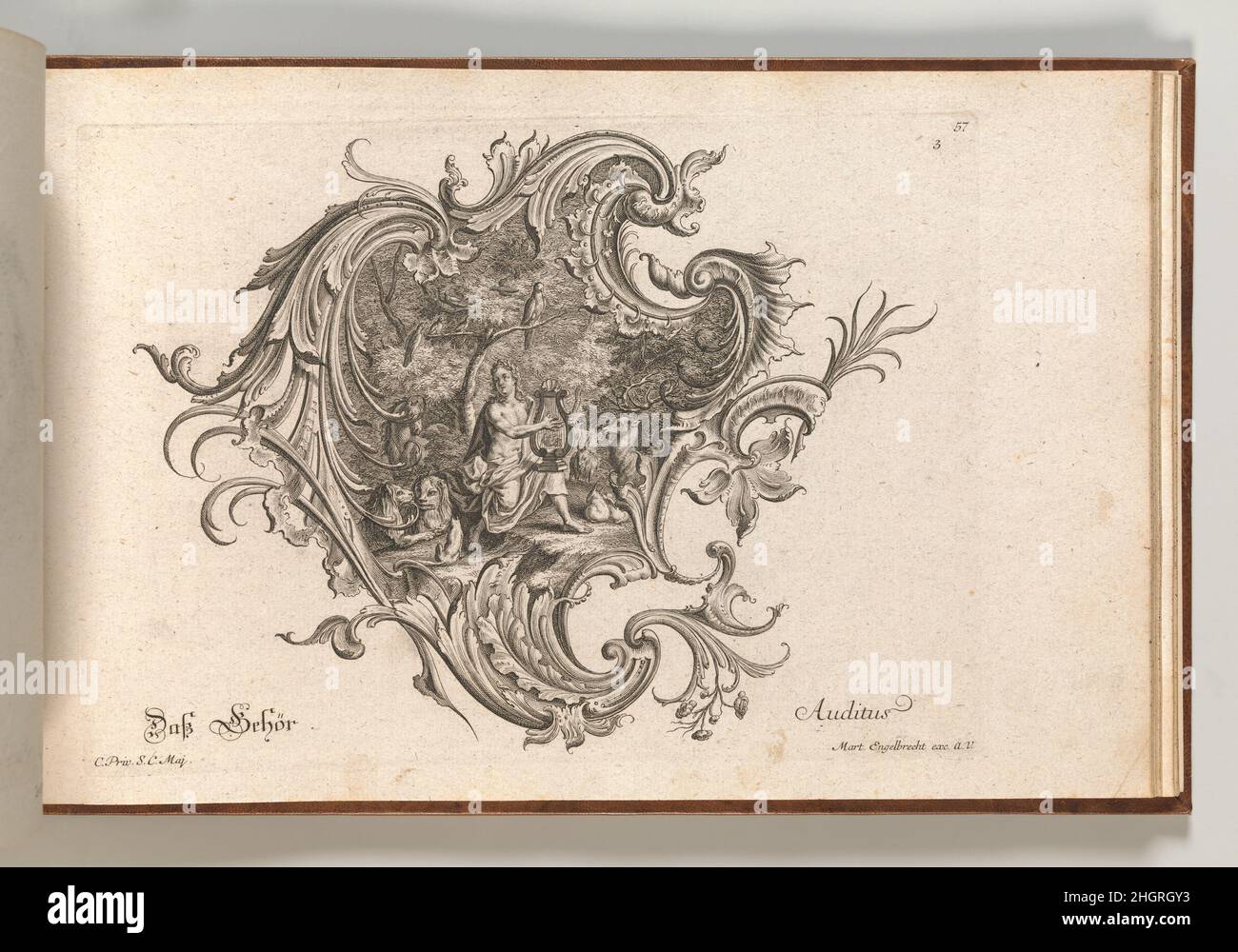 Design for a Cartouche and Representation of 'Hearing', Plate 3 from 'Neu Inventierte auf die artigste Facon Sehr nutzliche Schild.' Printed ca. 1750–56 Johann Georg Pintz Ornament print with a design for a rocaille cartouche, with a depiction of Orpheus playing for the animals in the central compartment, to illustrate the sense of 'hearing'. This print is bound in an album containing 27 series with a total of 122 ornament prints from the fund of the prominent Augsburg publisher Martin Engelbrecht.. Design for a Cartouche and Representation of 'Hearing', Plate 3 from 'Neu Inventierte auf die a Stock Photo