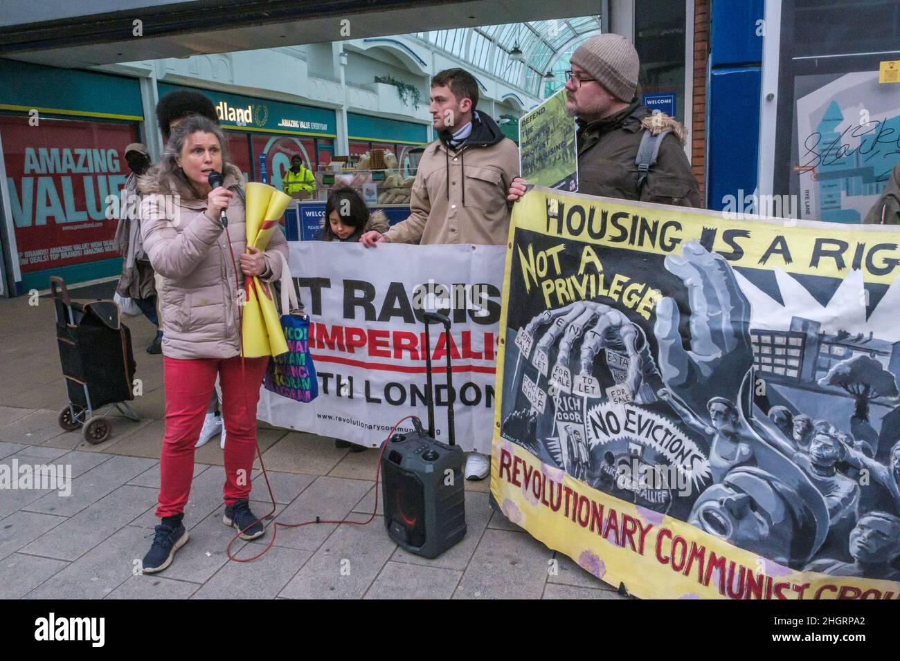 London, UK. 22nd Dec 2022. A woman from the Central Hill Estate in Lambeth speaks about their fight to stop estate demolition. Housing activists protest in front of the Aylesham Shopping Centre, Peckham calling for safe, decent and secure housing at reasonable rents for all. Southwark's Labour Council has demolished thousands of council homes, selling off land and homes for development almost entirely for private rent or sale, with little at social rents despite over 16,000 families on the council waiting list and 3,300 in temporary accommodation. Peter Marshall/Alamy Live News Stock Photo