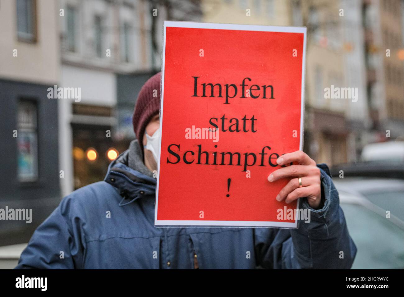 Dussedorf, NRW, Germany. 22nd Jan, 2022. Impfen statt Schimpfen' (vaccinate, don't moan) placard. A protest against compulsory vaccination, and related subjects marches through Dusseldorf city centre today, the capital of North Rhine-Westphalia. The march is met by groups of pro-vaccination, pro covid measures groups from activist and political groups as well as some pro-immigration and antifa protesters. Credit: Imageplotter/Alamy Live News Stock Photo