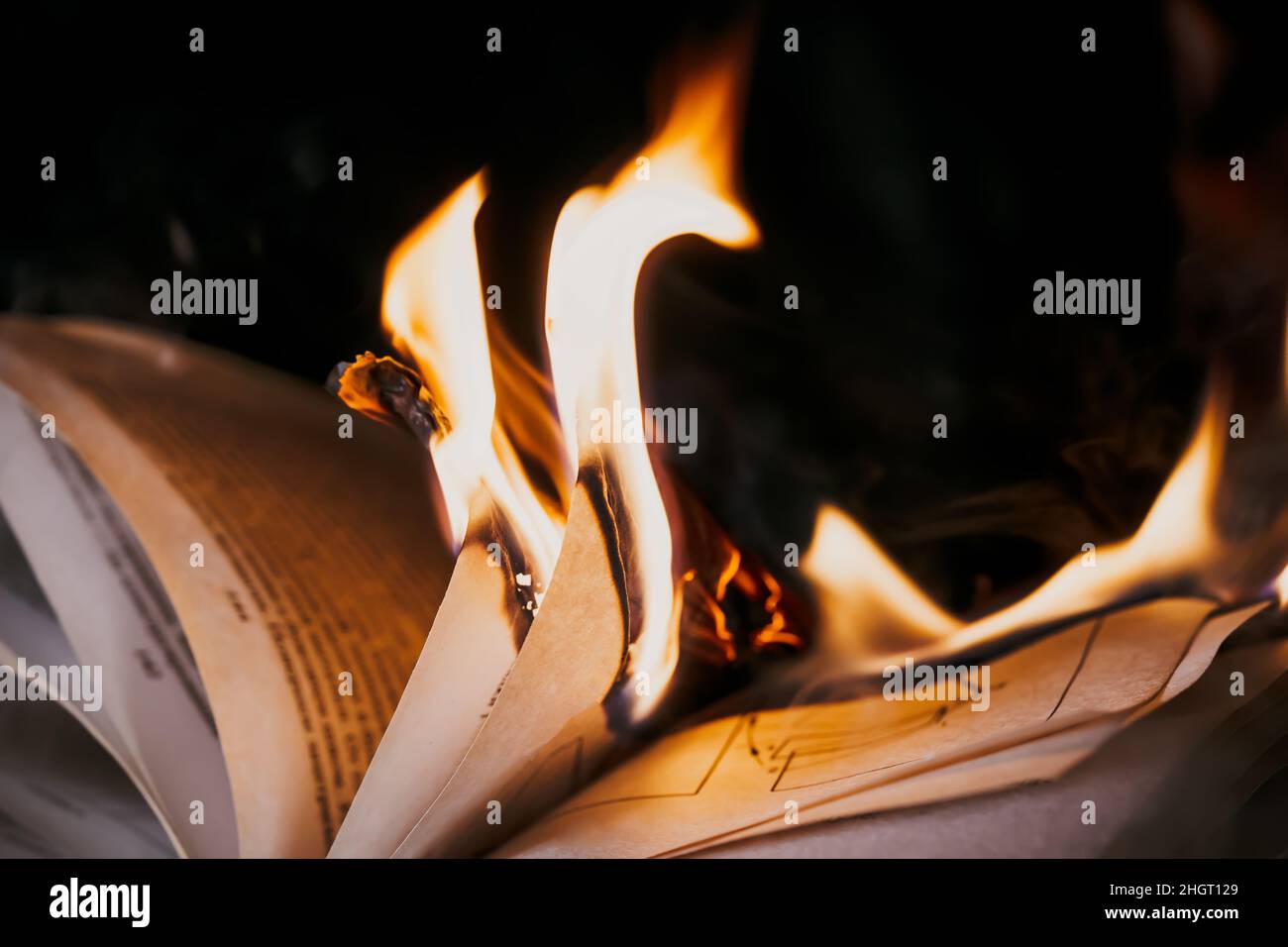Open Library Fire Open book is on fire, pages are engulfed in flames. Concept of ...