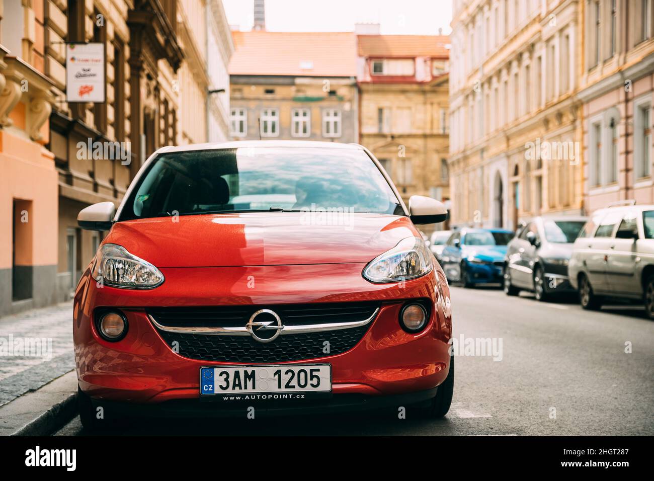 Red Opel Adam Car Parked In Street Of Residential Area. Opel Adam Is City Car Produced By German Car Manufacturer Opel Stock Photo