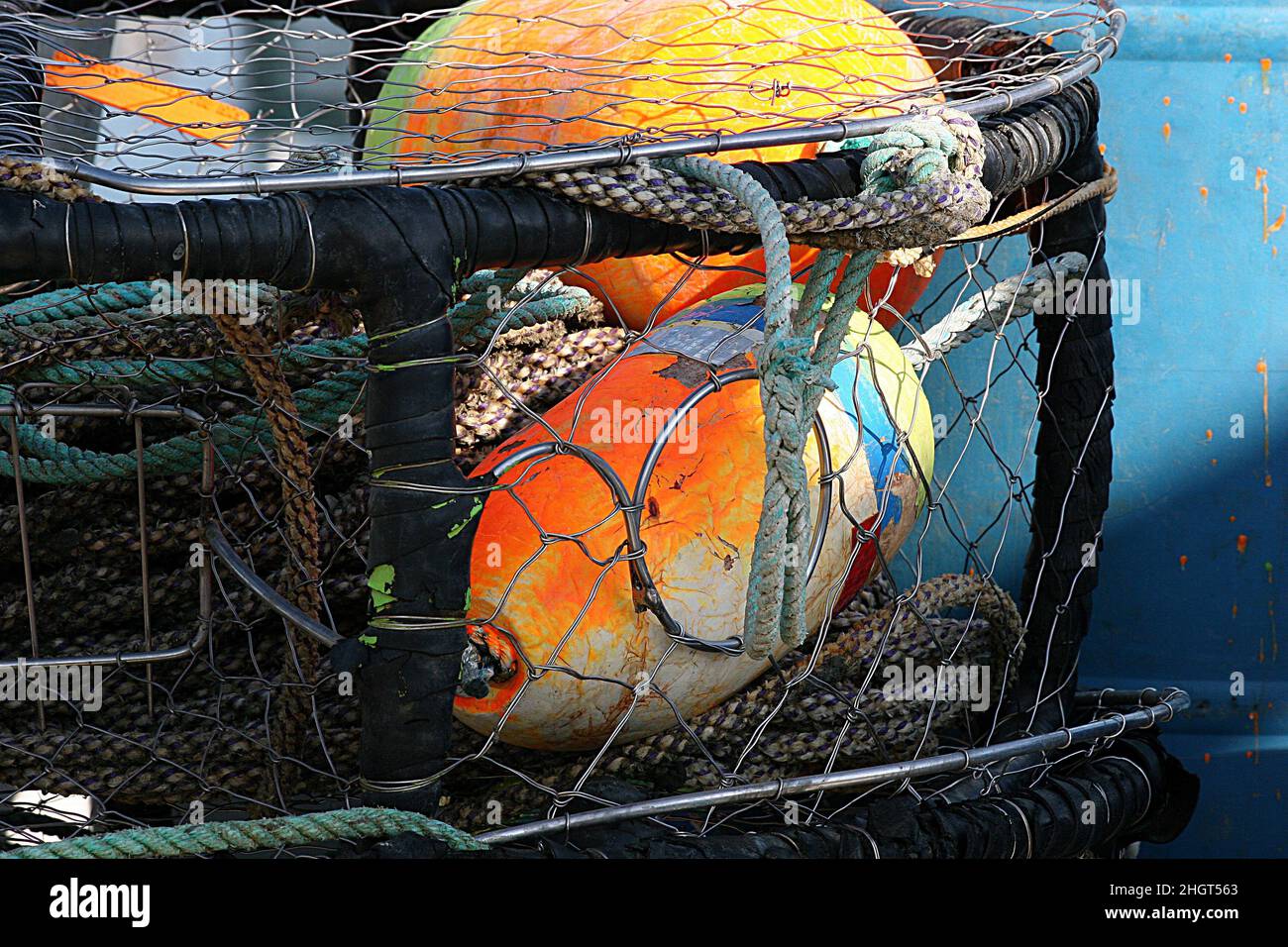 Mesh Container Holding Buoys and Ropes for Fishing Industry Stock Photo