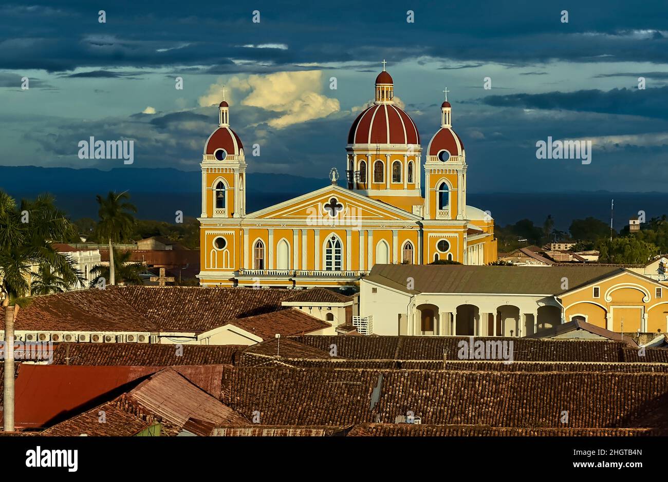 The beautiful neoclassical Granada Cathedral  and the roofs of colonial Granada, Nicaragua Stock Photo