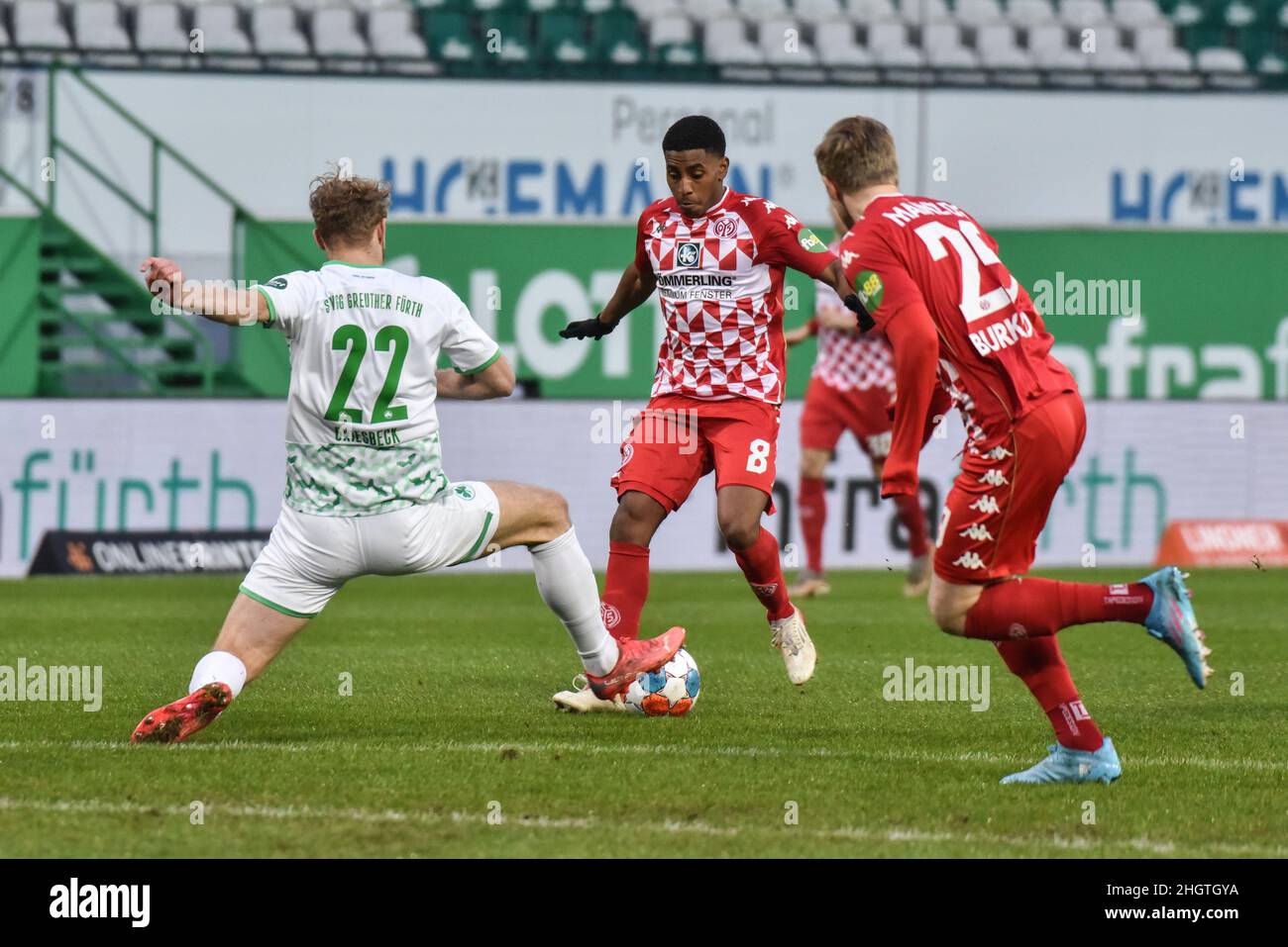 Germany ,Fuerth, Sportpark Ronhof Thomas Sommer - 22 Jan 2022 - Fussball, 1.Bundesliga - SpVgg Greuther Fuerth vs. FSV Mainz 05  Image: (fLTR) Sebastian Griesbeck (SpVgg Greuther Fürth,22) attempting to slide tackle Leandro Bareiro (Mainz, 8).  DFL regulations prohibit any use of photographs as image sequences and or quasi-video Stock Photo